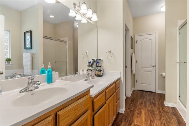 2 Moniave Ln, Bella Vista, AR 72715 - bathroom featuring a stall shower, double vanity, wood finished floors, and baseboards