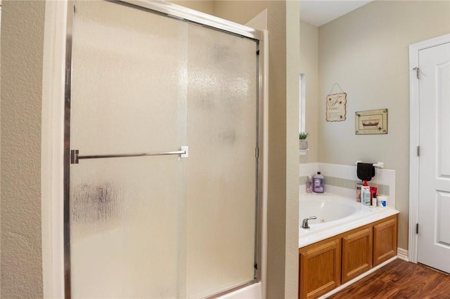2 Moniave Ln, Bella Vista, AR 72715 - bathroom with a shower stall, a garden tub, and wood finished floors
