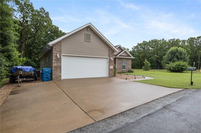2 Moniave Ln, Bella Vista, AR 72715 - view of front facade with driveway, a front lawn, brick siding, and an attached garage