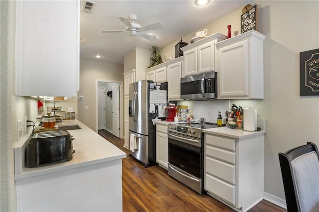 2 Moniave Ln, Bella Vista, AR 72715 - kitchen with stainless steel appliances, light countertops, white cabinets, ceiling fan, and dark wood-type flooring