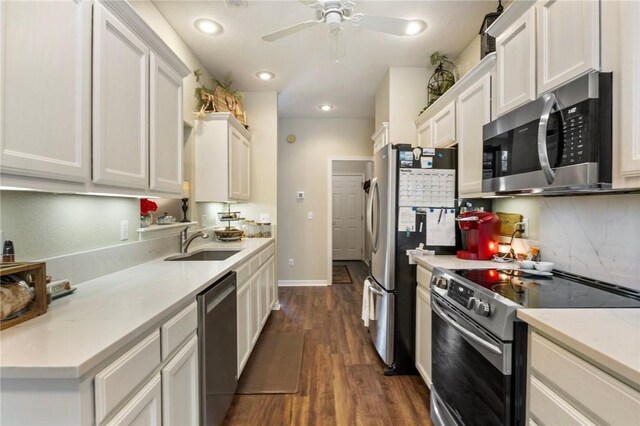 2 Moniave Ln, Bella Vista, AR 72715 - kitchen with stainless steel appliances, a sink, backsplash, dark wood finished floors, and white cabinets