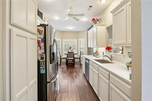 2 Moniave Ln, Bella Vista, AR 72715 - kitchen with appliances with stainless steel finishes, a ceiling fan, dark wood-style floors, light countertops, and a sink