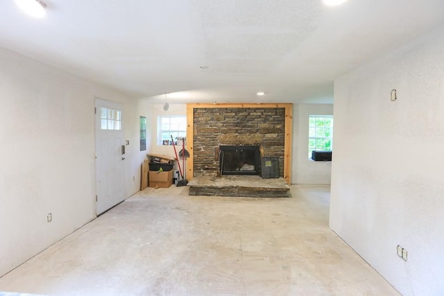 1732 Madison Unit 4316, Elkins, AR 72727 - unfurnished living room with a stone fireplace and concrete floors