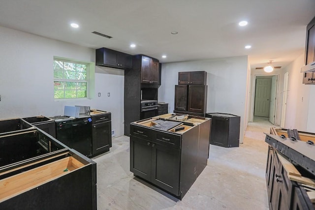 1732 Madison Unit 4316, Elkins, AR 72727 - kitchen with a center island, recessed lighting, dark cabinetry, and range