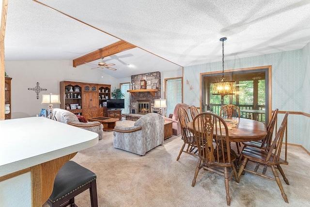 11 Yarmouth Dr, Bella Vista, AR 72715 - dining room with light colored carpet, wallpapered walls, a chandelier, a fireplace, and a textured ceiling