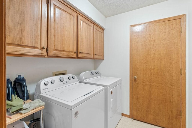 11 Yarmouth Dr, Bella Vista, AR 72715 - laundry room with washer and clothes dryer, cabinet space, and a textured ceiling