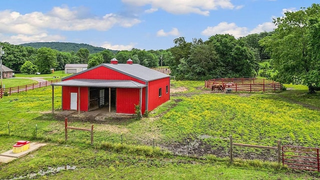 12976 Hummingbird Rd, Elkins, AR 72727 - view of pole building featuring a wooded view