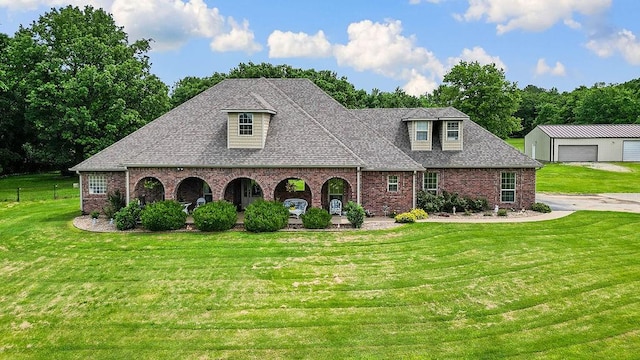 12976 Hummingbird Rd, Elkins, AR 72727 - view of front of home featuring an outdoor structure, brick siding, a garage, and roof with shingles