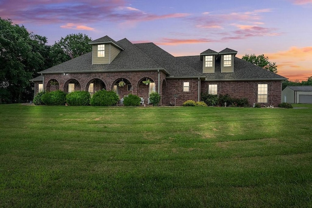 12976 Hummingbird Rd, Elkins, AR 72727 - view of front of home with brick siding, a yard, a shingled roof, and an outbuilding
