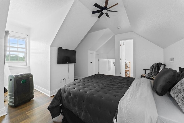 12976 Hummingbird Rd, Elkins, AR 72727 - bedroom featuring wood finished floors, lofted ceiling, baseboards, ceiling fan, and a textured ceiling