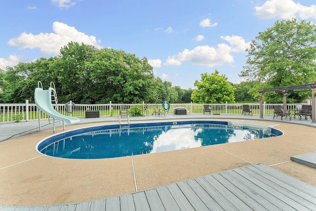12976 Hummingbird Rd, Elkins, AR 72727 - view of swimming pool with a water slide, a patio area, and view of wooded area