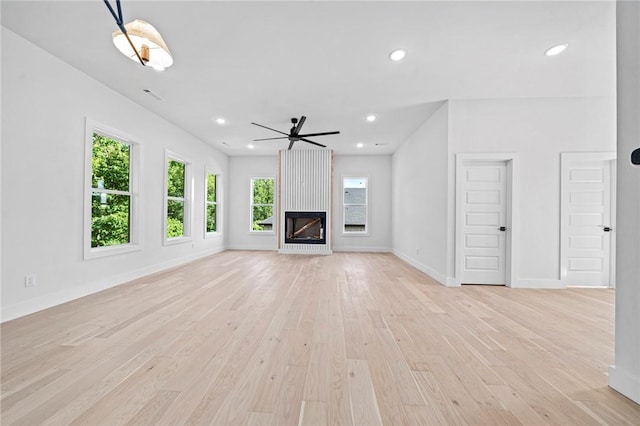 1421 Lee St, Pea Ridge, AR 72751 - unfurnished living room featuring light wood-type flooring, a ceiling fan, recessed lighting, and a large fireplace