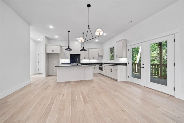 1421 Lee St, Pea Ridge, AR 72751 - kitchen featuring dark countertops, light wood-style floors, plenty of natural light, hanging light fixtures, and recessed lighting