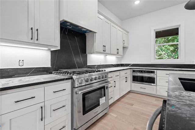 1421 Lee St, Pea Ridge, AR 72751 - kitchen featuring appliances with stainless steel finishes, white cabinetry, light wood-type flooring, ventilation hood, and recessed lighting