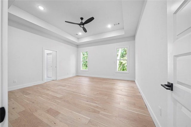 1421 Lee St, Pea Ridge, AR 72751 - empty room featuring light wood-style floors, ceiling fan, a tray ceiling, and recessed lighting