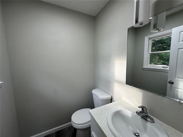 154 Mc 7059, Flippin, AR 72634 - half bath with vanity, toilet, wood finished floors, baseboards, and a textured wall