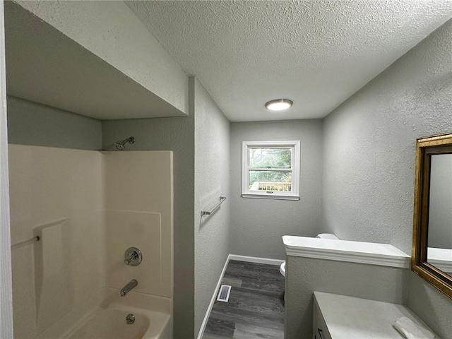 154 Mc 7059, Flippin, AR 72634 - bathroom with wood finished floors, vanity, a textured wall, bathing tub / shower combination, and toilet