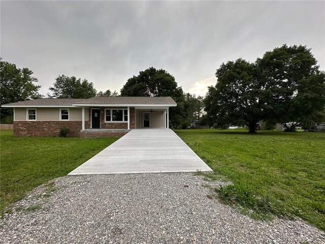 154 Mc 7059, Flippin, AR 72634 - ranch-style home featuring concrete driveway, stone siding, a carport, and a front lawn