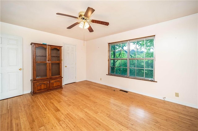 585 County Road 217, Berryville, AR 72616 - empty room featuring light wood-style floors, a ceiling fan, and baseboards
