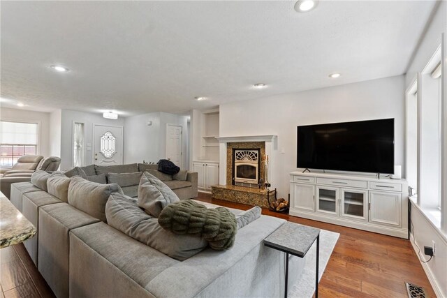4 Hillcrest Dr, Holiday Island, AR 72631 - living area featuring healthy amount of natural light, recessed lighting, wood finished floors, and a high end fireplace