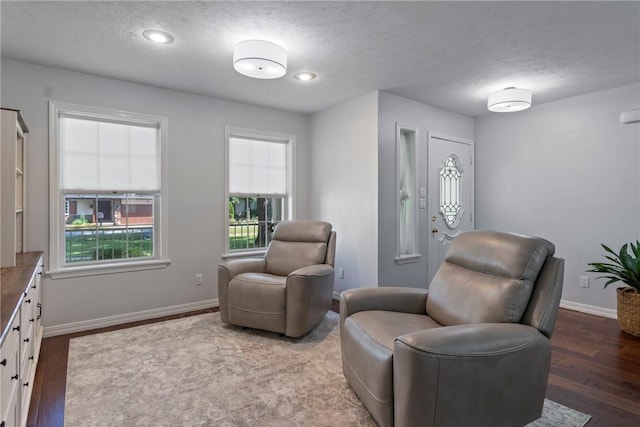 4 Hillcrest Dr, Holiday Island, AR 72631 - living area with a textured ceiling, wood finished floors, and baseboards