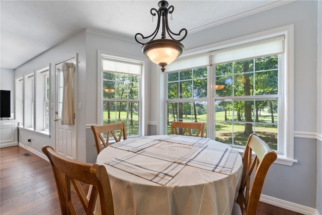 4 Hillcrest Dr, Holiday Island, AR 72631 - dining area featuring healthy amount of natural light, dark wood-style flooring, baseboards, and crown molding