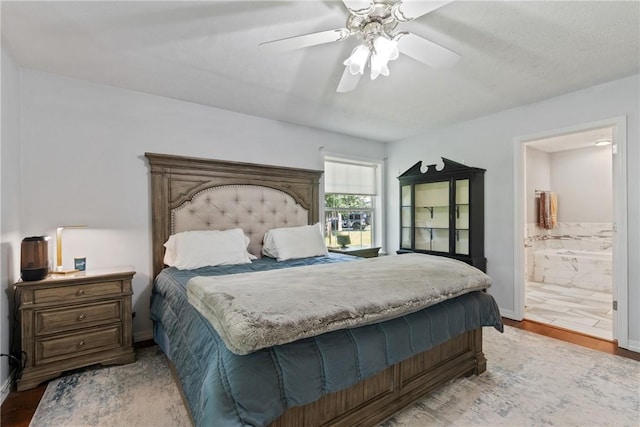 4 Hillcrest Dr, Holiday Island, AR 72631 - bedroom featuring light wood-style floors, connected bathroom, a ceiling fan, and baseboards
