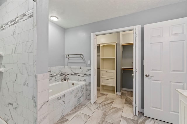 4 Hillcrest Dr, Holiday Island, AR 72631 - full bath featuring marble finish floors, a bath, a spacious closet, vanity, and baseboards