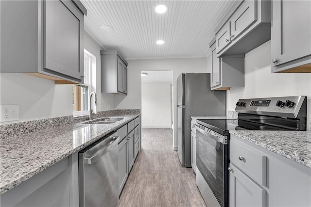 404 Hargis St, Huntsville, AR 72740 - kitchen with stainless steel appliances, gray cabinets, light wood-type flooring, light stone counters, and recessed lighting