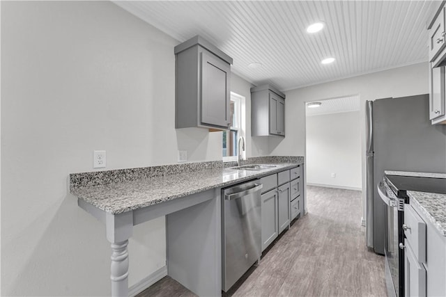 404 Hargis St, Huntsville, AR 72740 - kitchen featuring appliances with stainless steel finishes, gray cabinetry, light wood finished floors, light stone countertops, and recessed lighting