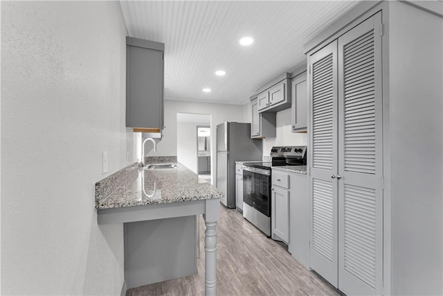 404 Hargis St, Huntsville, AR 72740 - kitchen with appliances with stainless steel finishes, gray cabinets, light wood-type flooring, recessed lighting, and light stone countertops