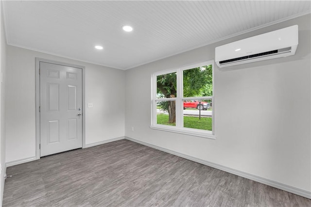 404 Hargis St, Huntsville, AR 72740 - spare room with a wall unit AC, wood finished floors, and recessed lighting