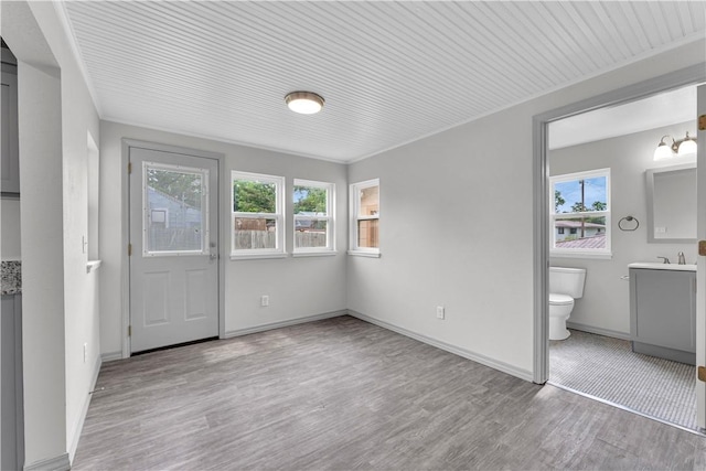 404 Hargis St, Huntsville, AR 72740 - unfurnished bedroom featuring wood finished floors and connected bathroom