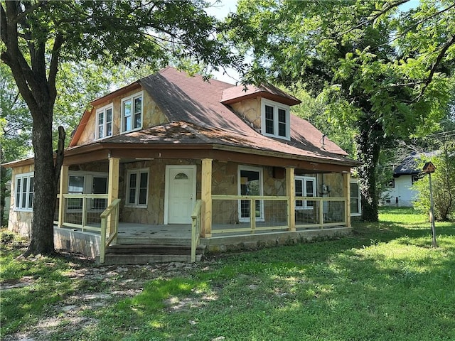 301 W Bean St, Lincoln, AR 72744 - view of front facade featuring stone siding, covered porch, and a front yard