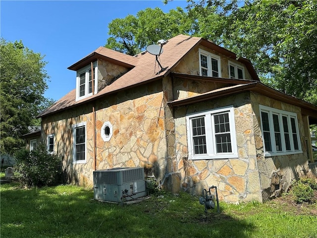 301 W Bean St, Lincoln, AR 72744 - view of side of property with stone siding, central AC unit, and a yard
