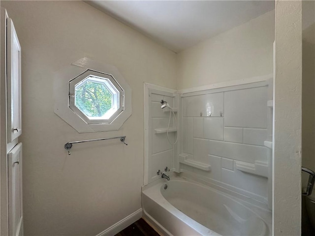301 W Bean St, Lincoln, AR 72744 - bathroom featuring washtub / shower combination and baseboards