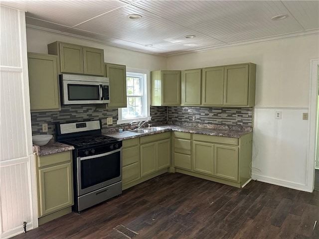 301 W Bean St, Lincoln, AR 72744 - kitchen featuring appliances with stainless steel finishes, green cabinets, a sink, decorative backsplash, and crown molding