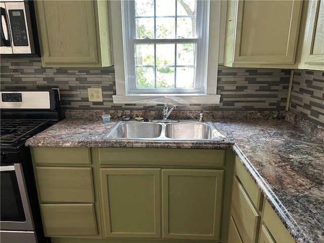 301 W Bean St, Lincoln, AR 72744 - kitchen with stainless steel appliances, a sink, and backsplash
