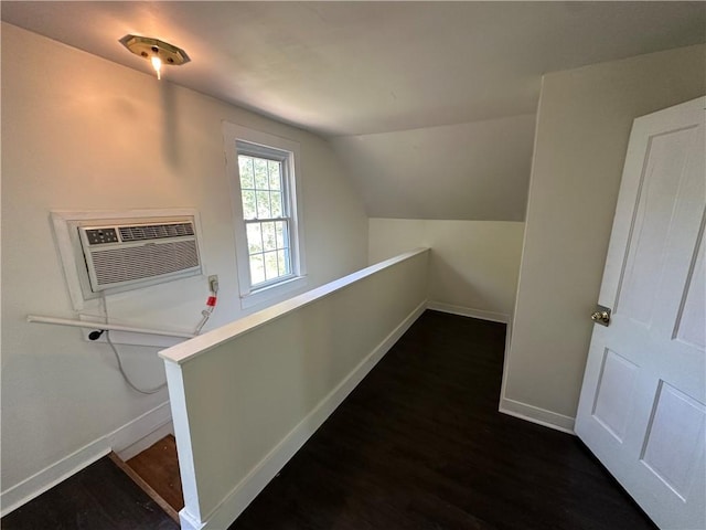301 W Bean St, Lincoln, AR 72744 - hallway with baseboards, lofted ceiling, wood finished floors, a wall mounted AC, and an upstairs landing