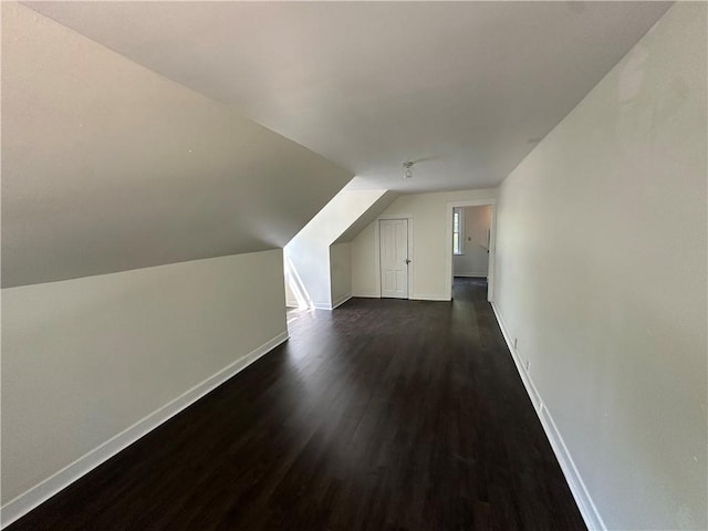 301 W Bean St, Lincoln, AR 72744 - additional living space with dark wood-style floors, baseboards, and vaulted ceiling