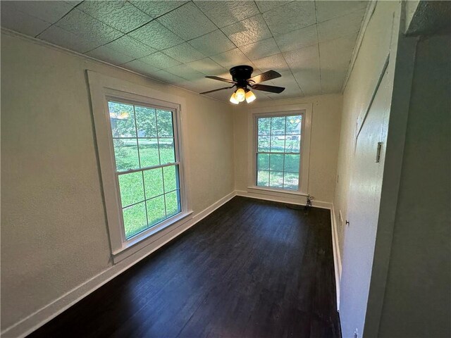 301 W Bean St, Lincoln, AR 72744 - spare room with baseboards, dark wood-style flooring, and ceiling fan
