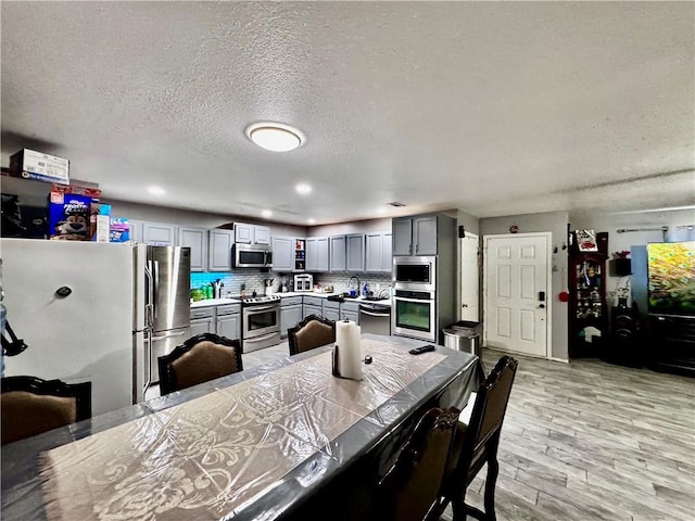 1297 Homestead Loop, Springdale, AR 72764 - dining space featuring a textured ceiling and light wood-style floors