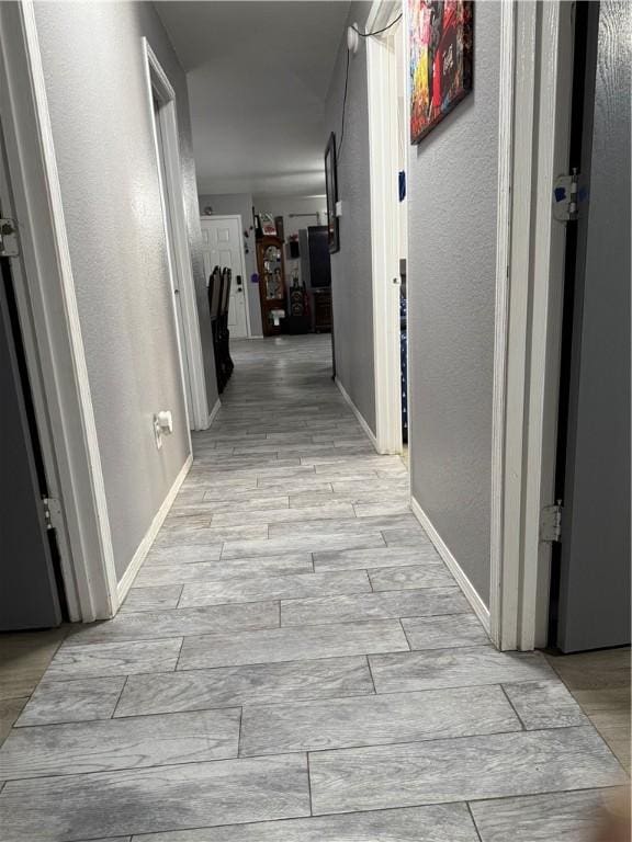 1269 E Homestead Loop, Springdale, AR 72764 - corridor with a textured wall and light wood-style flooring
