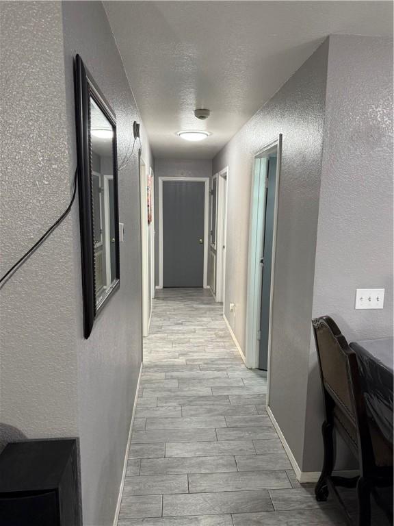 1269 E Homestead Loop, Springdale, AR 72764 - corridor with a textured wall, light wood-style flooring, and a textured ceiling