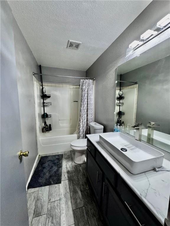 1269 E Homestead Loop, Springdale, AR 72764 - bathroom with a textured ceiling, wood finished floors, vanity, and shower / bath combination with curtain