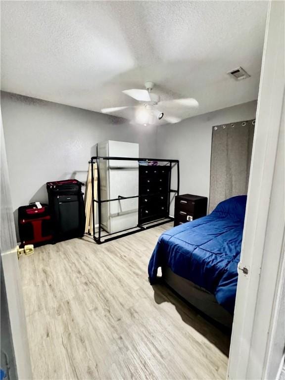 1269 E Homestead Loop, Springdale, AR 72764 - bedroom with a textured ceiling, wood finished floors, and a ceiling fan