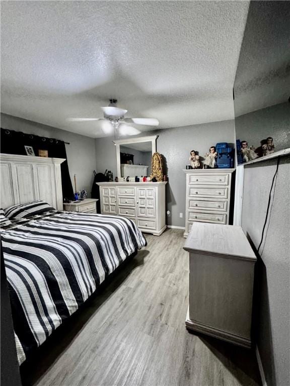 1269 E Homestead Loop, Springdale, AR 72764 - bedroom featuring light wood-type flooring, a textured ceiling, and ceiling fan