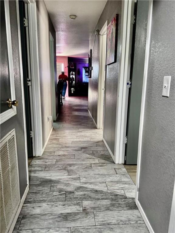 1269 E Homestead Loop, Springdale, AR 72764 - hall featuring a textured wall and wood finished floors