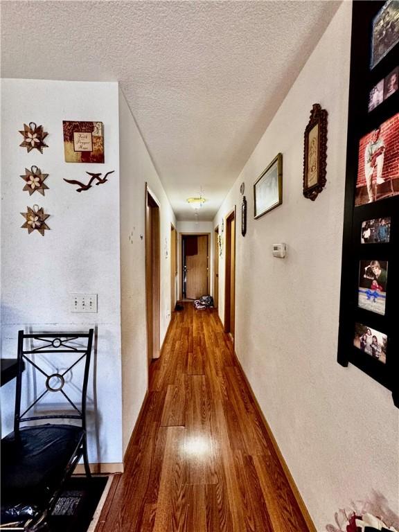 1269 E Homestead Loop, Springdale, AR 72764 - hall with wood finished floors and a textured ceiling