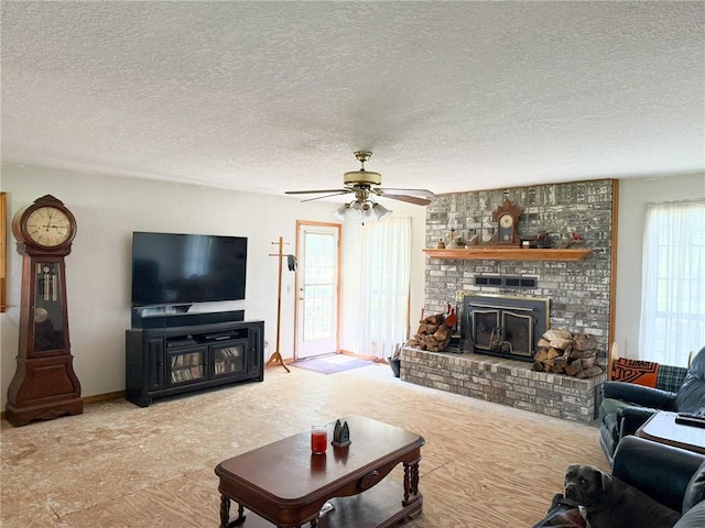 291 S Industrial Park Rd, Prairie Grove, AR 72753 - living room with a ceiling fan, a fireplace, and a textured ceiling